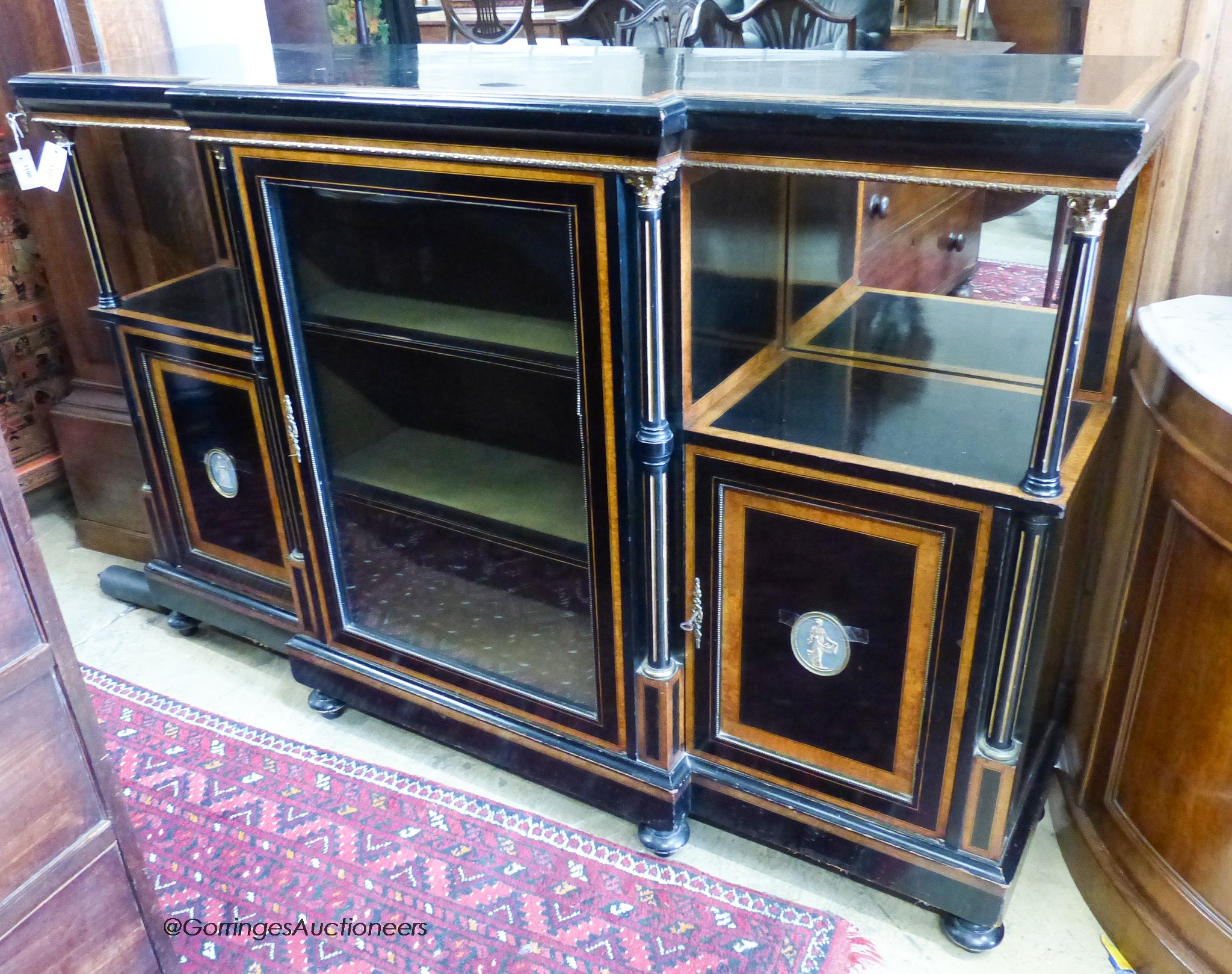 A late Victorian amboyna, banded ebonised break front side cabinet. W-162, D-42, H-107cm.